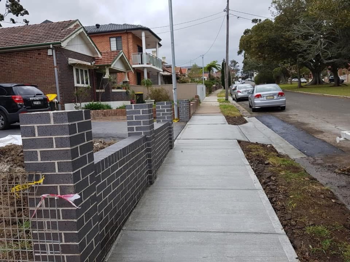 New concrete footpath and council crossover along a Sydney street