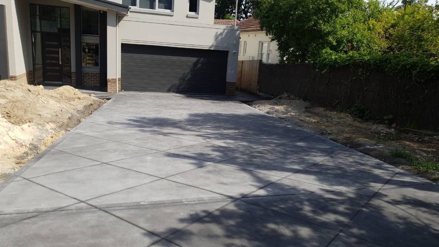 Plain concrete driveway to a double garage on a Sydney home