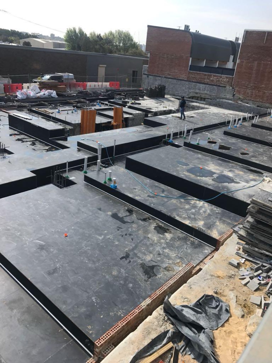 Suspended slab formwork decking laid out across beams, ready for steel reinforcement