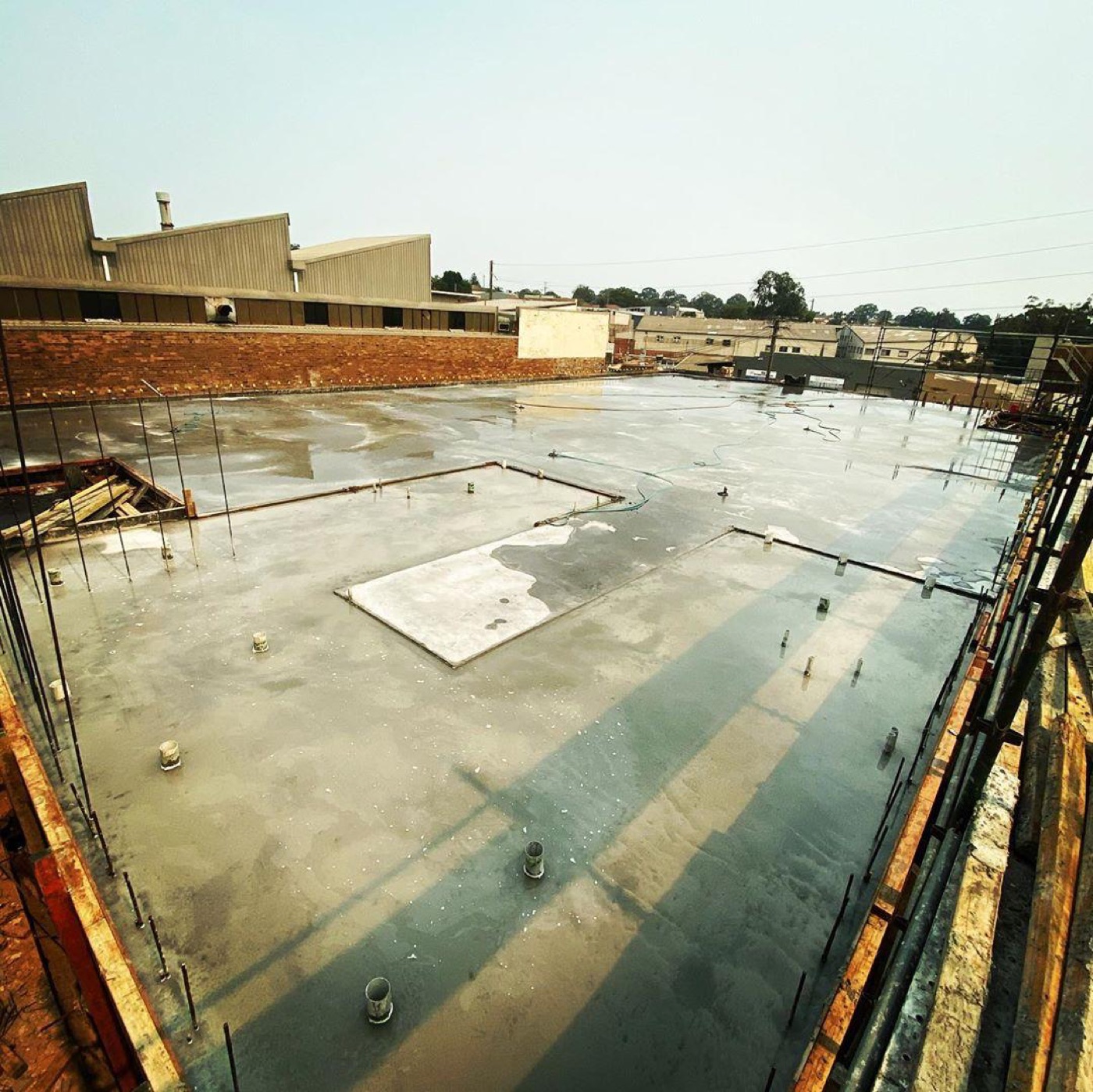 Structural suspended concrete slab poured above ground with edge formwork