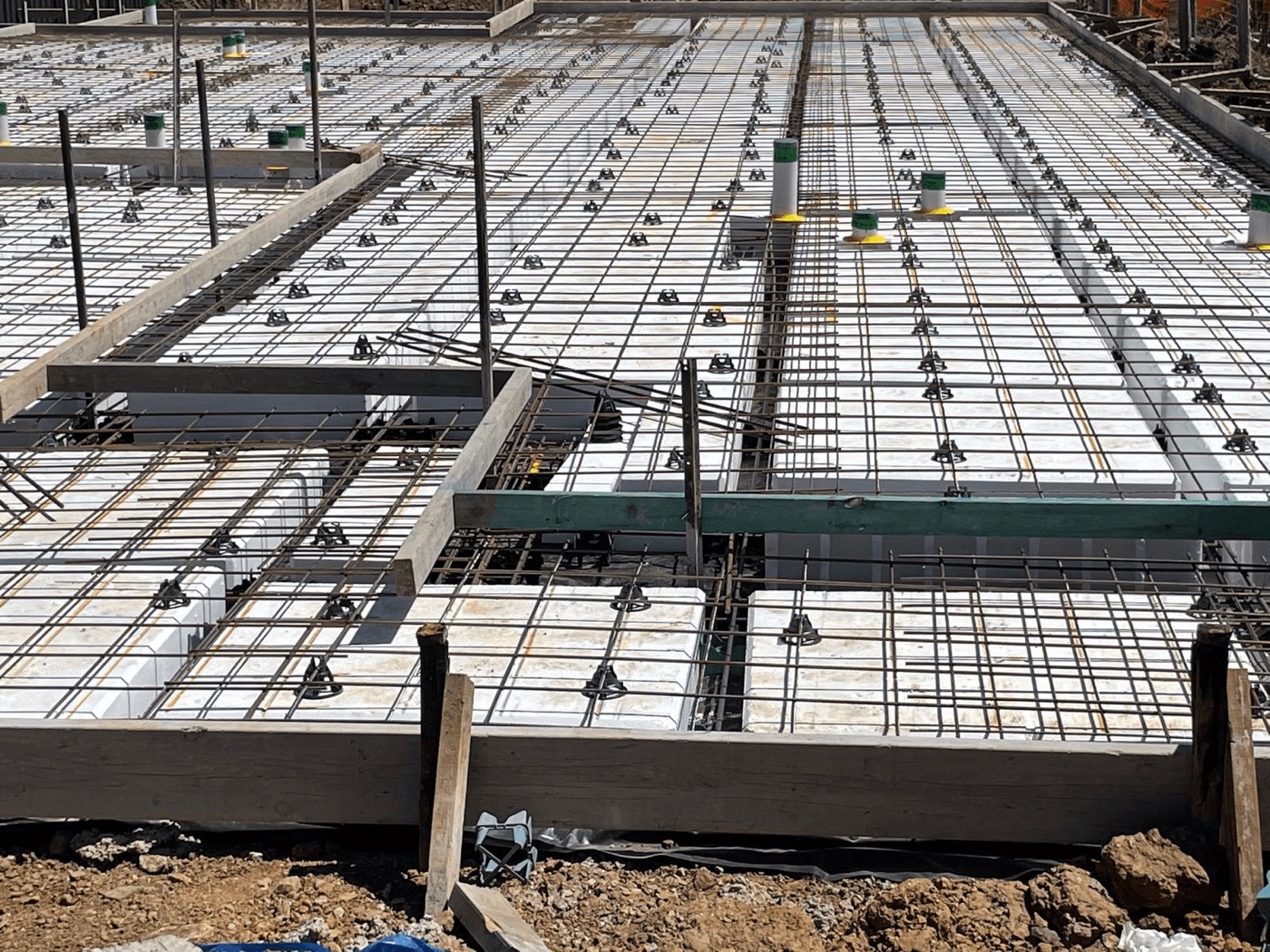 Waffle pod slab with polystyrene void formers and steel reinforcement mesh laid on a Sydney residential site